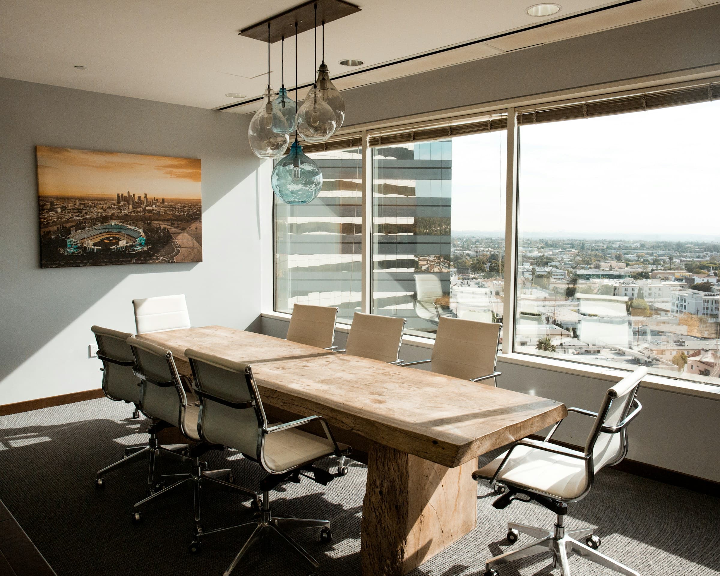 A boardroom table with a city view
