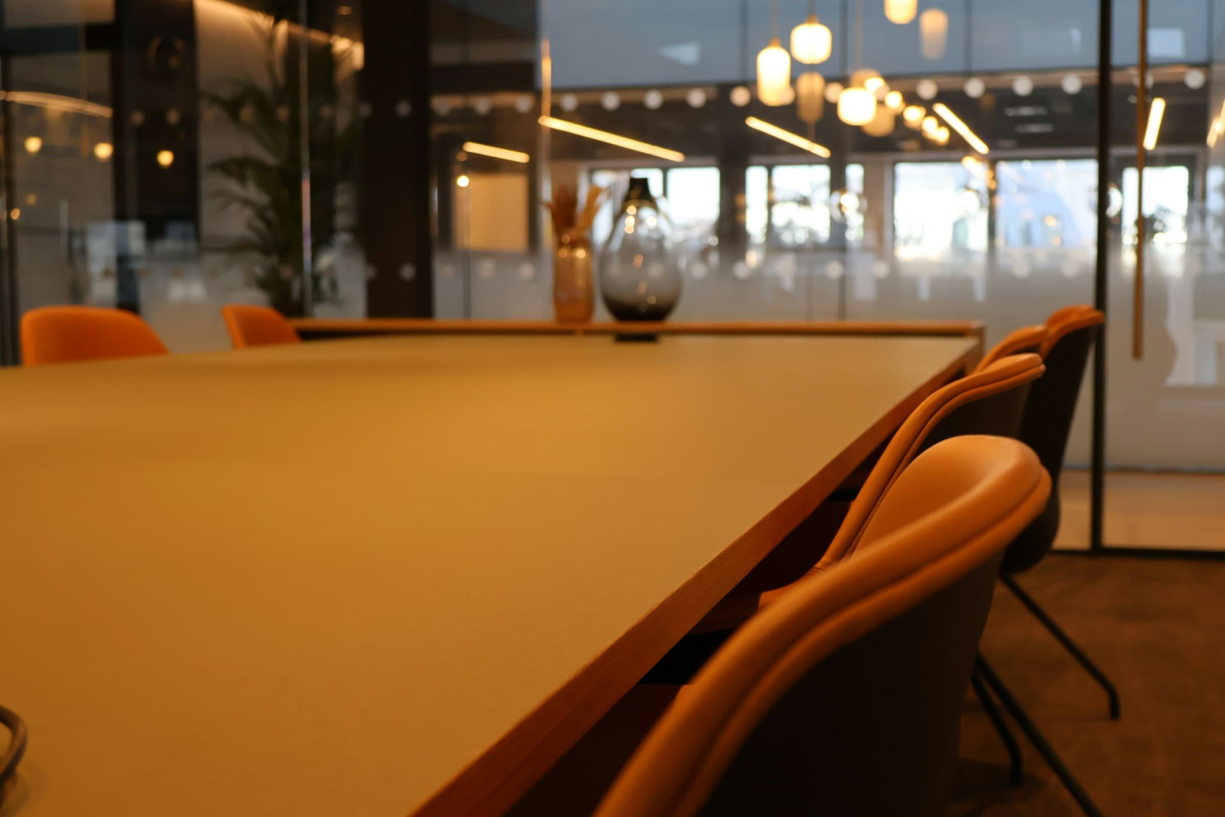 Orange chairs at a table in soft evening light