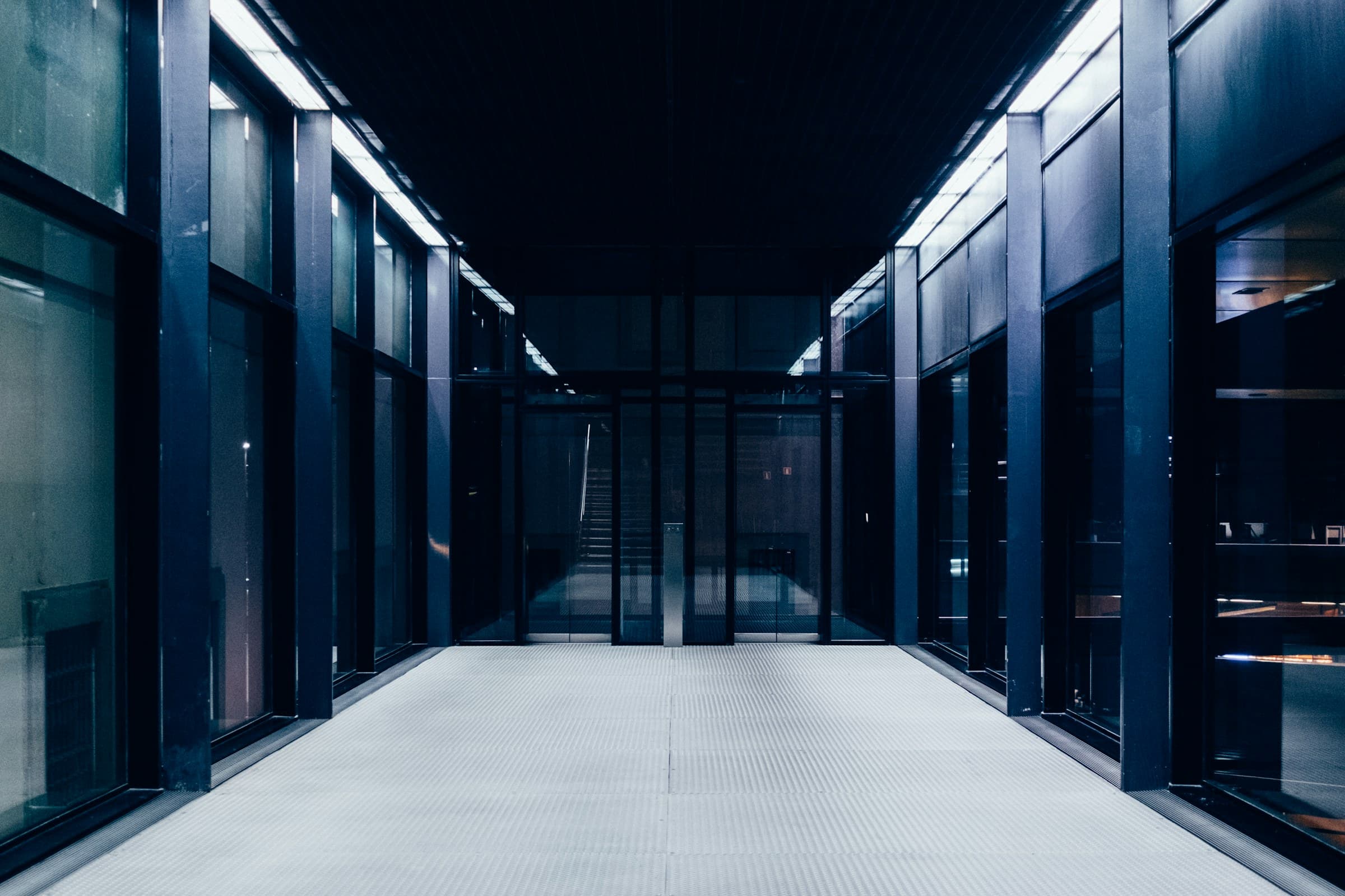 A dark data-centre corridor between rows of cabinets
