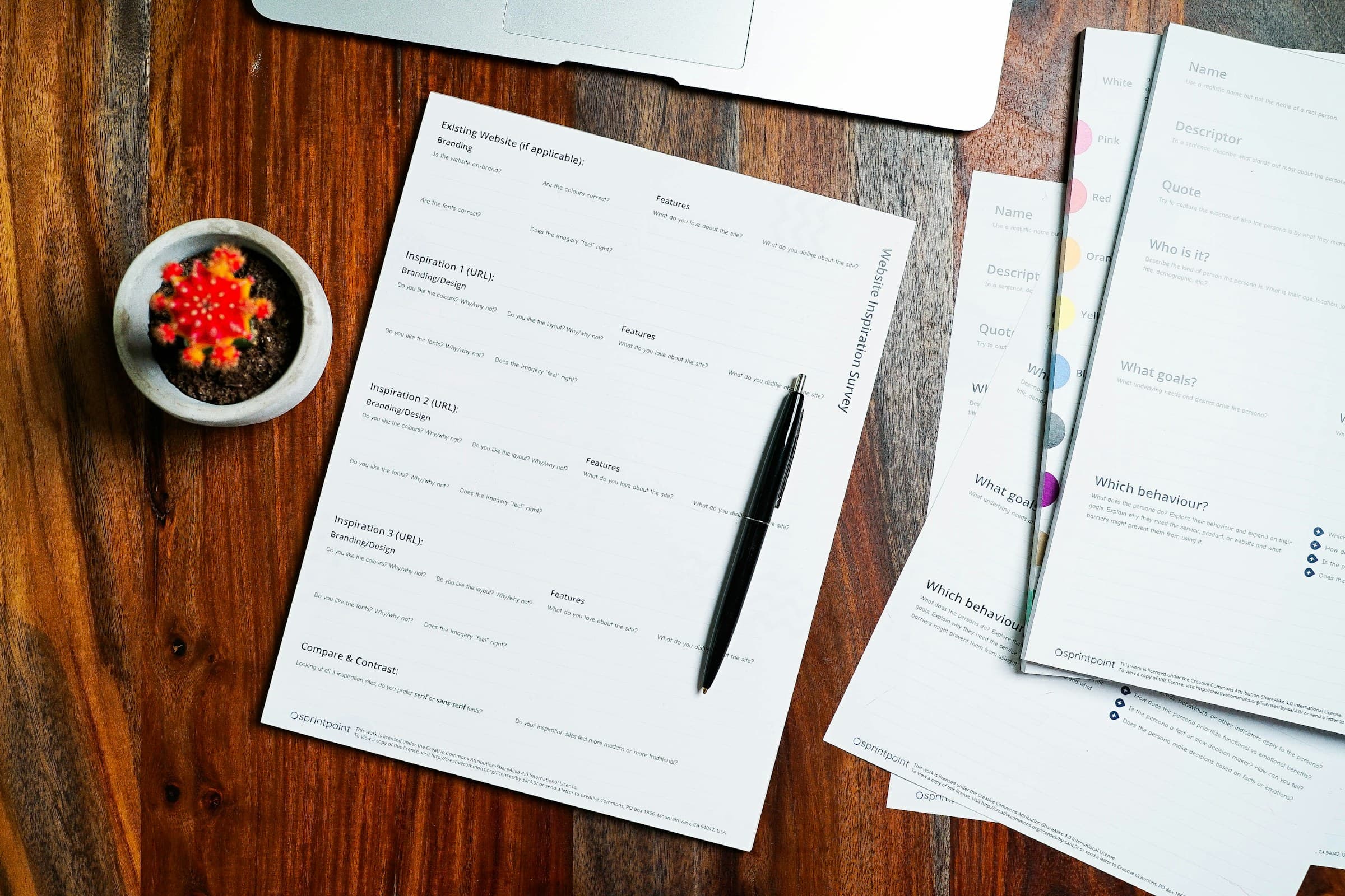 Forms and a pen on a wooden table