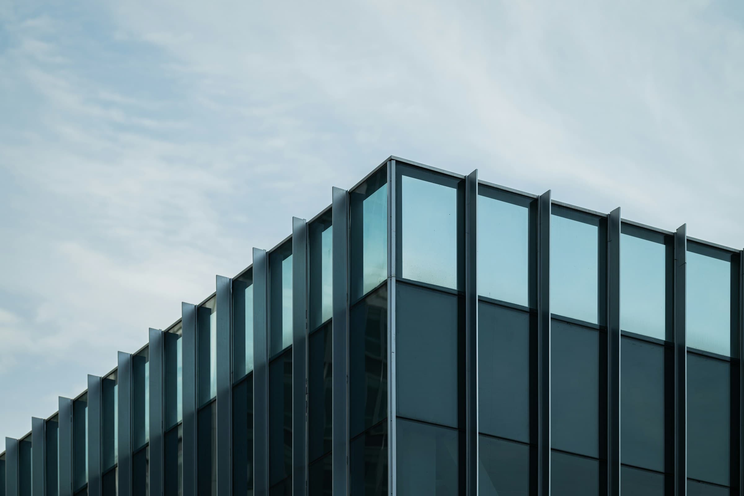 The corner of a dark glass office block