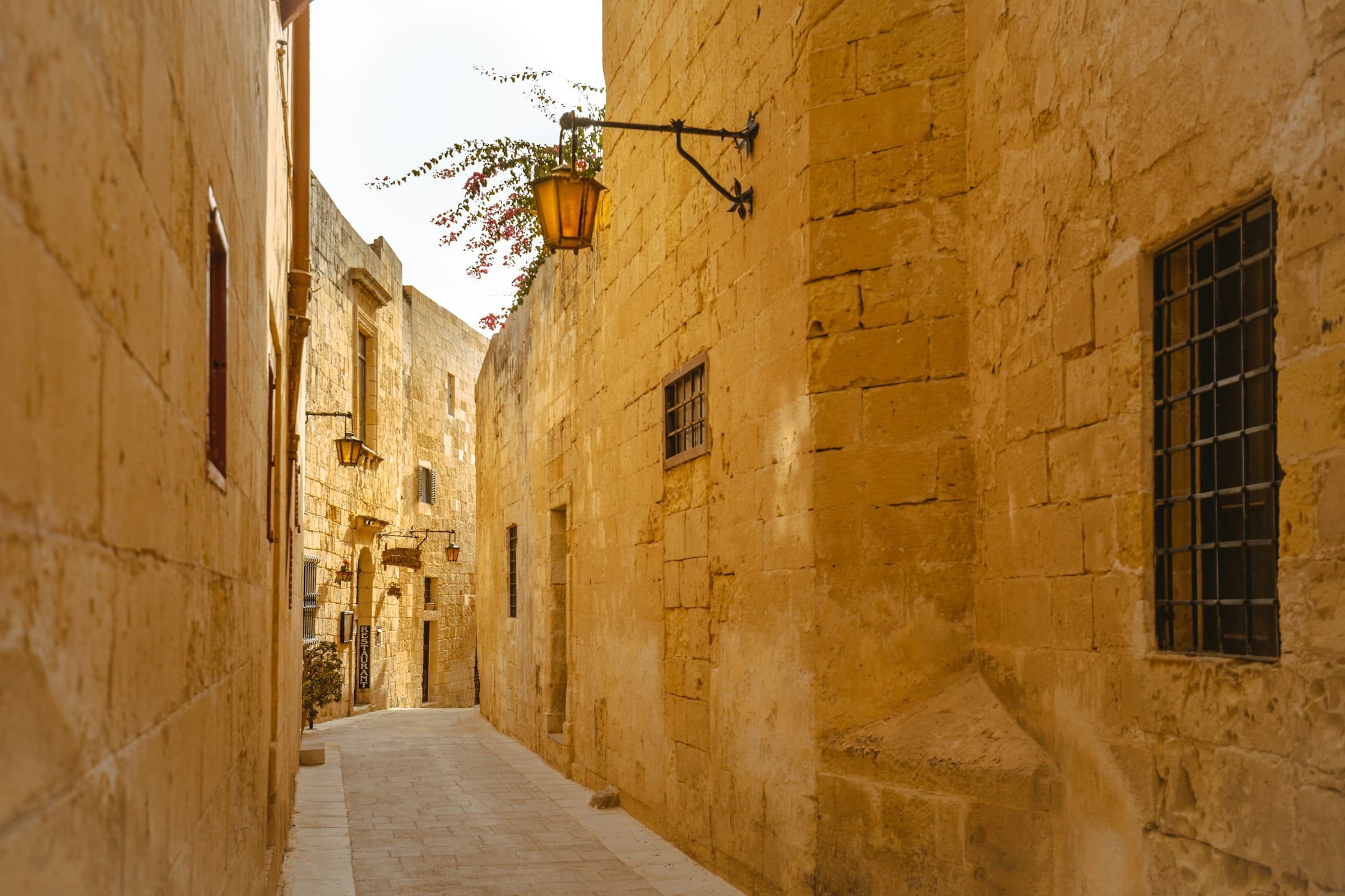 A golden limestone alley in low sun