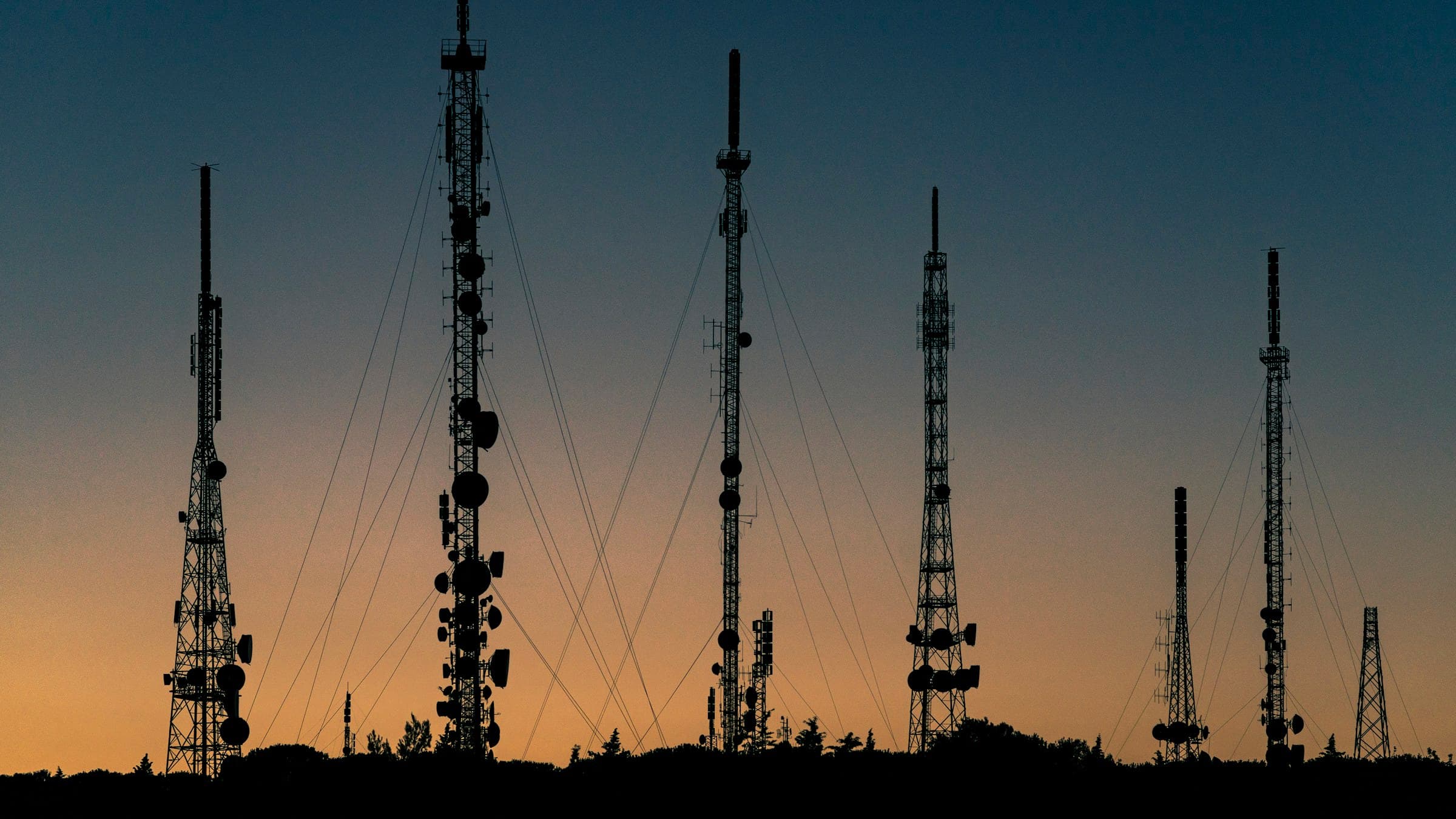 Telecommunication masts silhouetted at dusk
