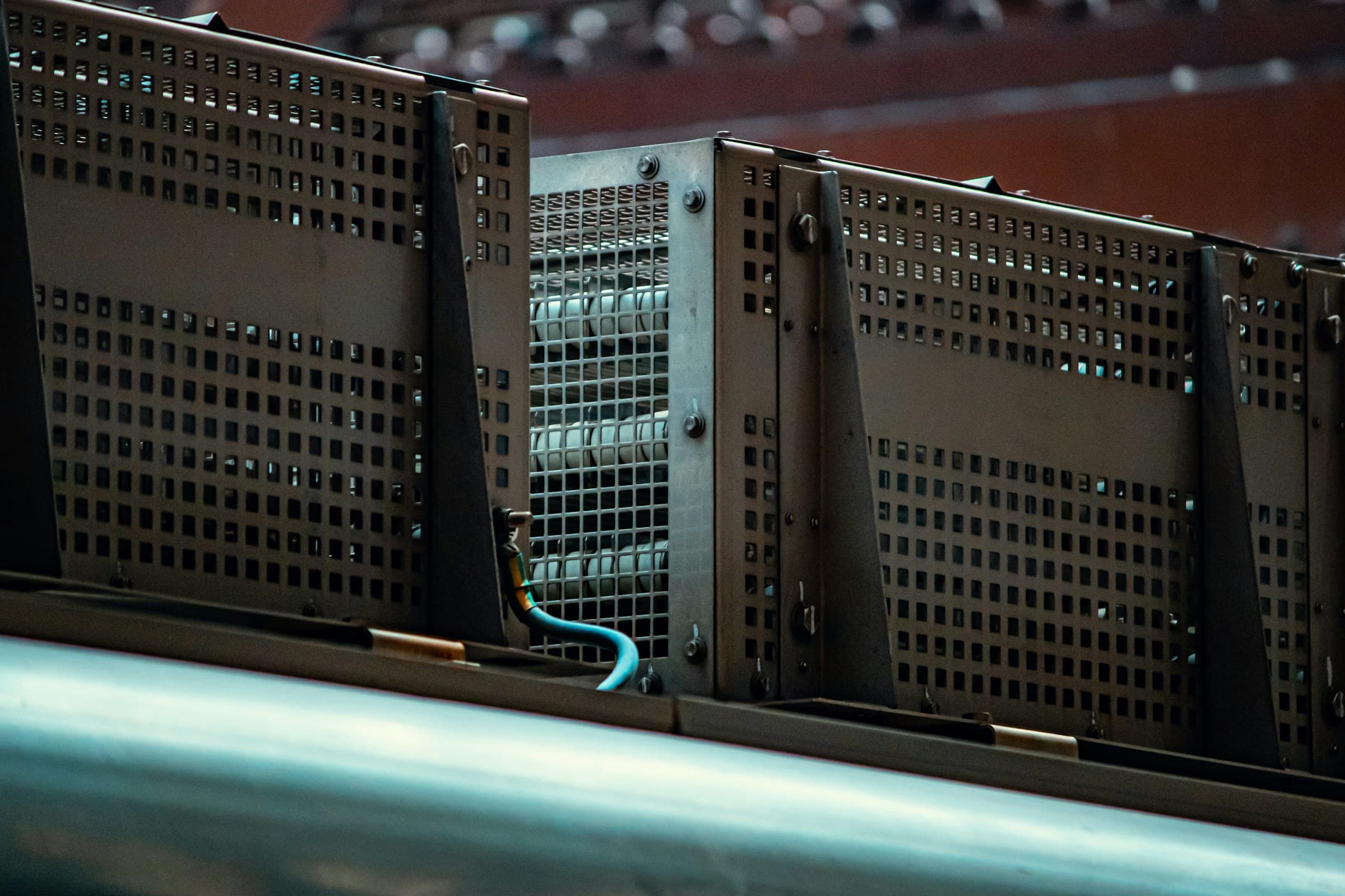 Dark perforated rack panels with a single cable